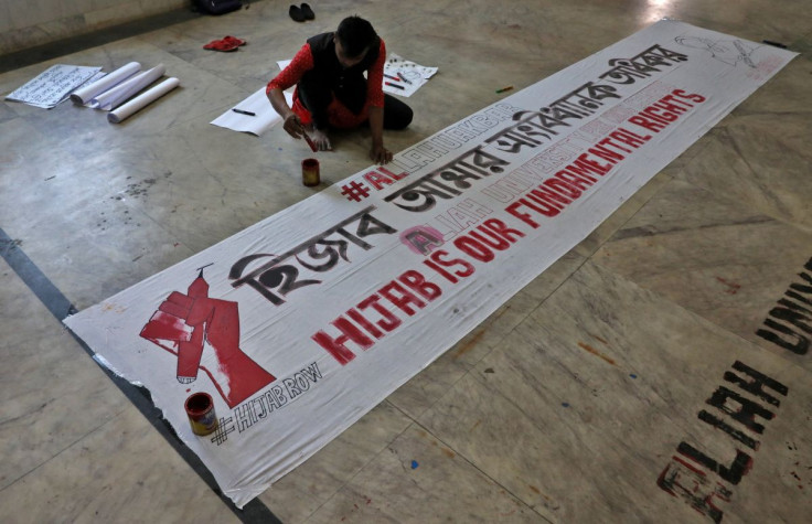 A Muslim student prepares a banner before taking part in a protest against the recent hijab ban in few colleges of Karnataka state, at Aliah University in Kolkata, India, February 9, 2022. 