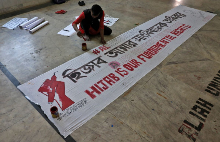 A Muslim student prepares a banner before taking part in a protest against the recent hijab ban in few colleges of Karnataka state, at Aliah University in Kolkata, India, February 9, 2022.