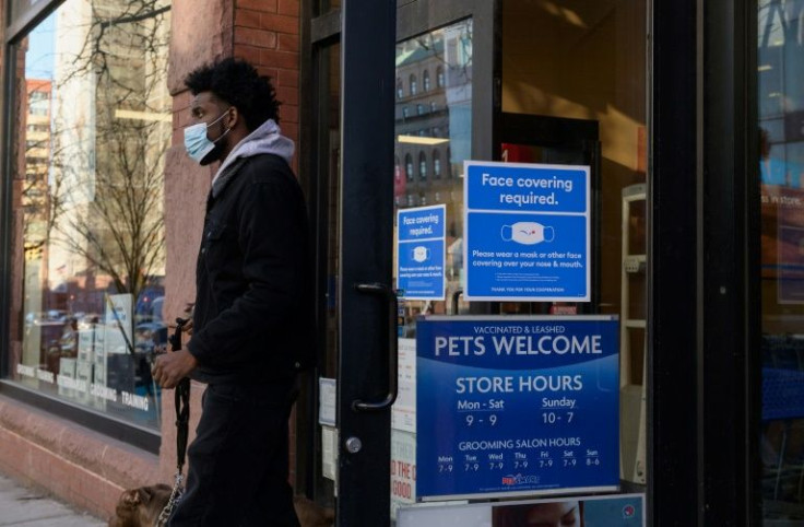 A person wearing a face mask leaves a store on January 26, 2022 in New York City; mask-wearing became a political battleground in the United States in the early days of the pandemic