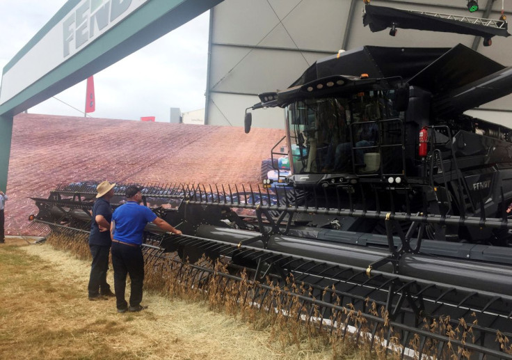 Farmers look at a large grain harvester during the Agrishow farm equipment fair in Ribeirao Preto, Brazil, May 1, 2019. 