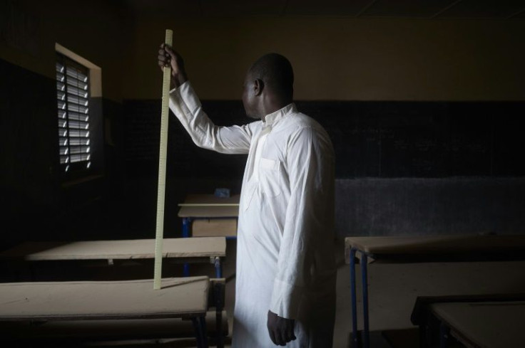 'Sidiki' poses in a classroom. His teaching career came to a halt in November 2017 when jihadists raided his school, forced him to his knees and placed an assault rifle against his head. He survived, but the school was closed