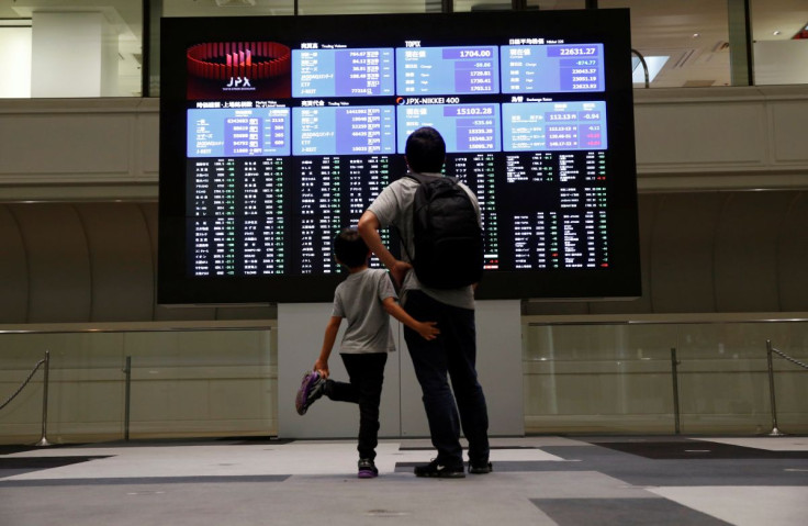 Visitors look at a stock quotation board at Tokyo Stock Exchange in Tokyo Japan, October 11, 2018. 