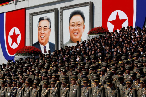 Senior military officials watch a parade as portraits of late North Korean leaders Kim Il Sung and Kim Jong Il are seen in the background at the main Kim Il Sung square in Pyongyang, North Korea, September 9, 2018. 