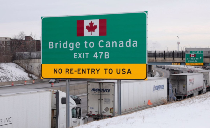Commercial Trucks idle on the side of the expressway after the Ambassador Bridge to Canada shut down in Detroit, Michigan, U.S., February 8, 2022. Picture taken February 8, 2022.