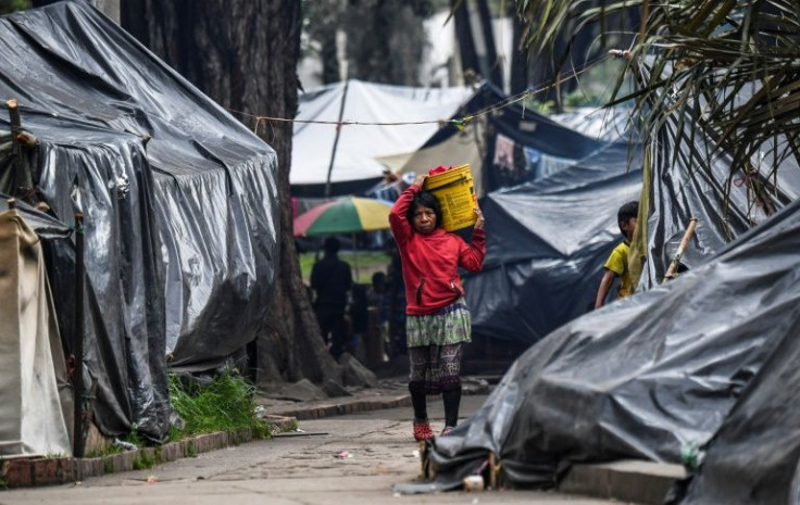 An Embera indigenous woman walks in a makeshift camp in Bogota's National Park, on February 7, 2022