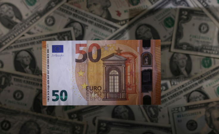 A Euro banknote is seen placed on U.S. Dollar banknotes in this illustration taken, November 28, 2021. 