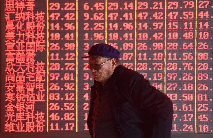 A man stands in front of an electronic board displaying stock information at a brokerage firm in Hangzhou, Zhejiang province, China April 1, 2019. Picture taken April 1, 2019.