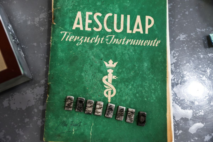 The dies from a tattoo kit, and a manual, are displayed at an Israeli auction house which says they were used on inmates at Auschwitz death camp, in Gilo, a Jewish settlement in the Israeli-Occupied West Bank November 2, 2021. Picture taken November 2, 20