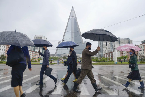 People wearing protective face masks walk amid concerns over the new coronavirus disease (COVID-19) in Pyongyang, North Korea May 15, 2020, in this photo released by Kyodo. Mandatory credit Kyodo/via REUTERS 