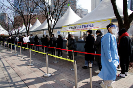 People wait in line to undergo the coronavirus disease (COVID-19) test at a temporary testing site set up at City Hall Plaza in Seoul, South Korea, February 10, 2022.  