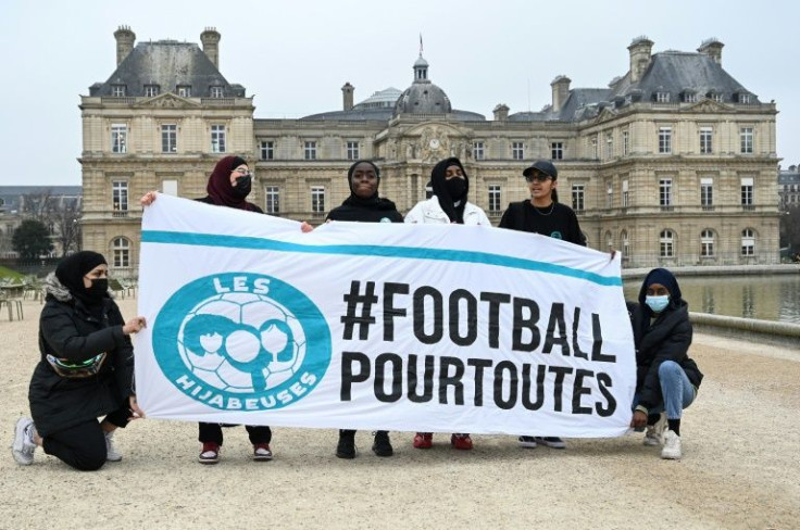 Muslim footballers protest in front of the French Senate with a banner reading "#Football for everyone".