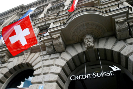 Switzerland's national flag flies below a logo of Swiss bank Credit Suisse at its headquarters at the Paradeplatz square in Zurich, July 31, 2019.  