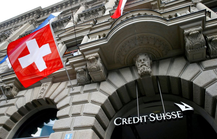 Switzerland's national flag flies below a logo of Swiss bank Credit Suisse at its headquarters at the Paradeplatz square in Zurich, July 31, 2019.  