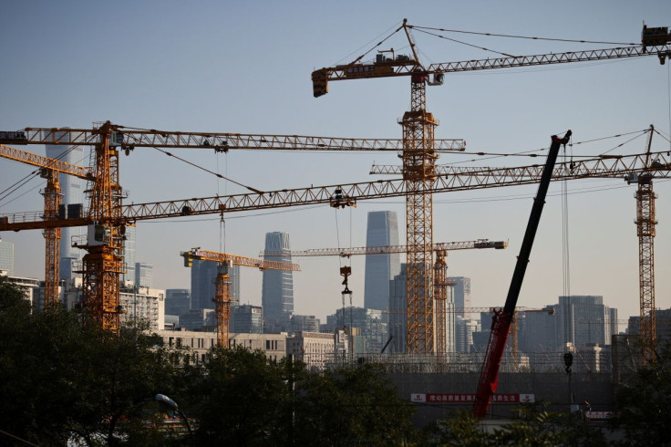 A view shows cranes in front of the skyline of the Central Business District (CBD) in Beijing, China, October 18, 2021.   