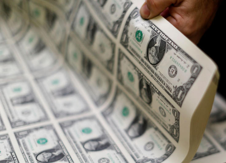 United States one dollar bills are curled and inspected during production at the Bureau of Engraving and Printing in Washington November 14, 2014.   