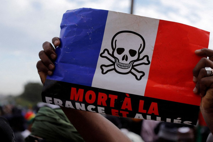 A supporter holds a flag of France, with the drawing of a skull on it, as he participates in a demonstration called by Mali's transitional government after ECOWAS (Economic Community of West African States) imposed sanctions in Bamako, Mali, January 14, 2