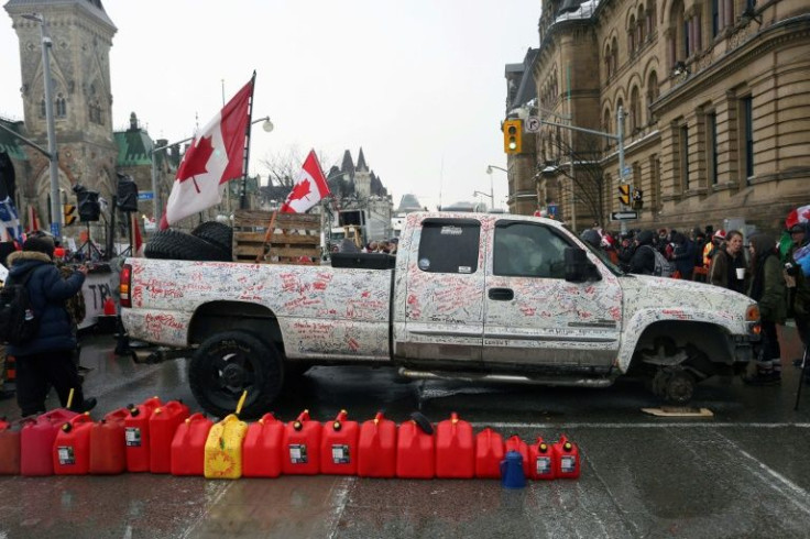 Fuel cans are lined up in front of a pick-up truck without a front wheel as demonstrators protest vaccine mandates implemented by Prime Minister Justin Trudeau on February 10, 2022 in Ottawa, Canada