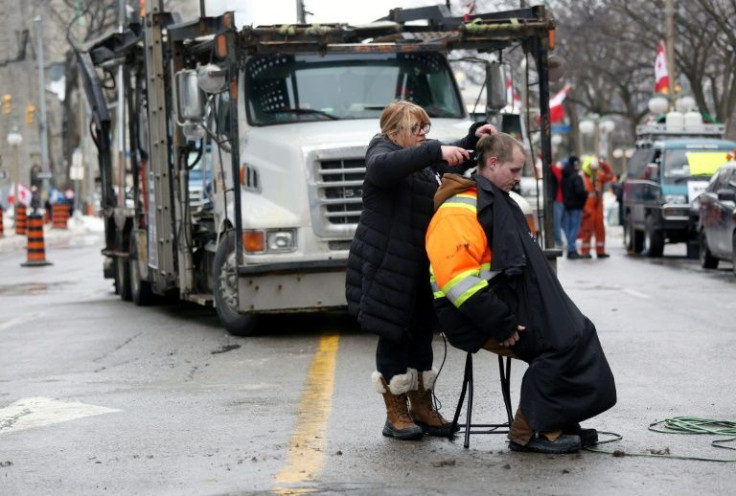 A truck driver gets a haircut during the Canadian trucker protest over Covid restrictions