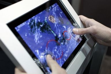 A gamer uses a Fling analog game controller for the Apple iPad during the Electronic Entertainment Expo or E3 in Los