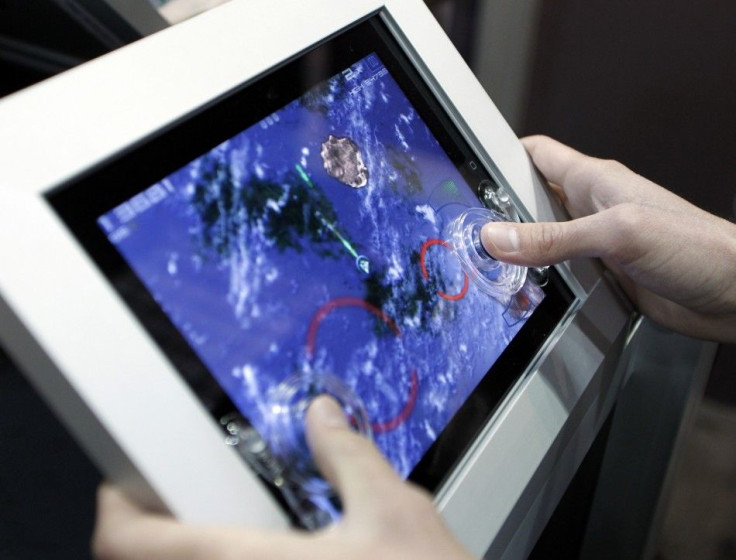 A gamer uses a Fling analog game controller for the Apple iPad during the Electronic Entertainment Expo or E3 in Los
