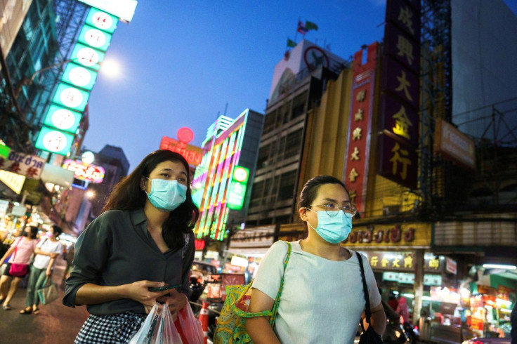 People wearing face masks shop for street food in Chinatown amid the spread of the coronavirus disease (COVID-19) in Bangkok, Thailand, January 6, 2021. 