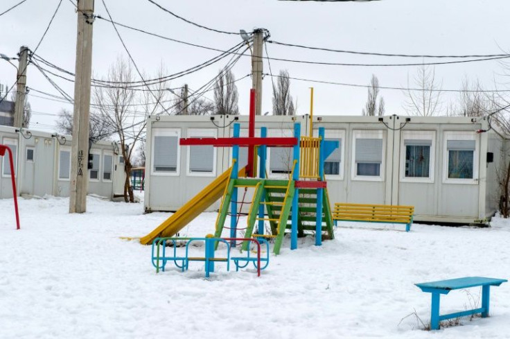 The prefabricated housing was meant to be a temporary solution, but years later 175 people, including 70 children, are still living in the cluster of white cubes