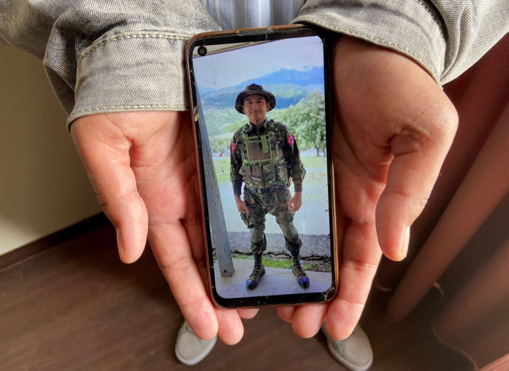 Kaung Thu Win, who said he served as a captain in Myanmar's military before defecting in late December, shows a photograph of himself wearing an army uniform on his mobile phone, during an interview with Reuters at an undisclosed location in northeastern