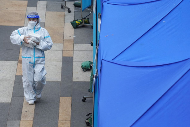 A medical worker walks past a makeshift testing centre for the coronavirus disease (COVID-19) following the outbreak, outside a shopping mall at Sha Tin district, in Hong Kong, China, February 7, 2022.
