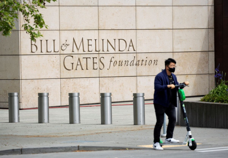 A person passes by on a scooter in front of the Bill & Melinda Gates Foundation in Seattle, Washington, U.S. May 5, 2021.  