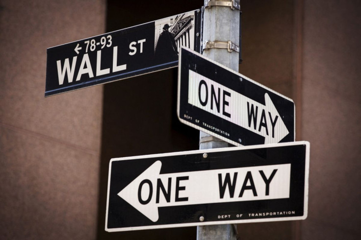 A 'Wall St' sign is seen above two 'One Way' signs in New York August 24, 2015. 