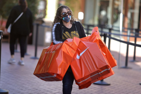 A woman carries Nike shopping bags at the Citadel Outlet mall, as the global outbreak of the coronavirus disease (COVID-19) continues, in Commerce, California, U.S., December 3, 2020. 