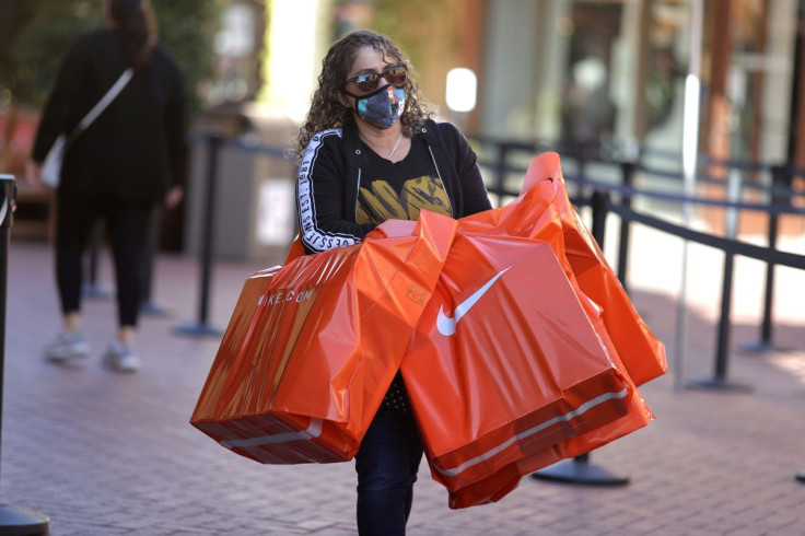 A woman carries Nike shopping bags at the Citadel Outlet mall, as the global outbreak of the coronavirus disease (COVID-19) continues, in Commerce, California, U.S., December 3, 2020. 