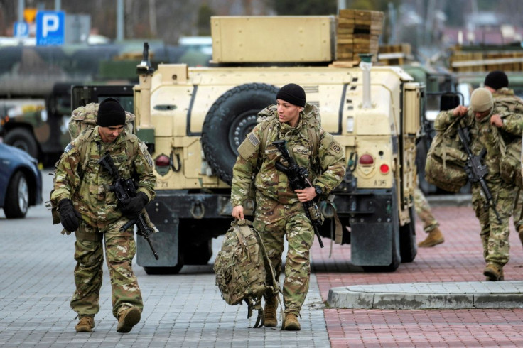 U.S. soldiers from the 82nd Airborne Division walk near the G2A Arena following their arrival at Rzeszow-Jasionka Airport, in Jasionka, Poland February 8, 2022. Patryk Ogorzalek/Agencja Wyborcza.pl via REUTERS ATTENTION EDITORS - THIS IMAGE WAS PROVIDED B