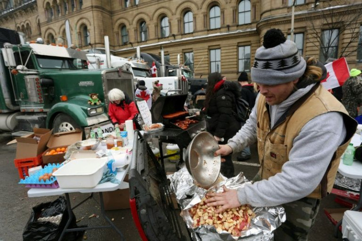 Protesters prepare food at a makeshift kitchen as demonstrators continue to push back against Covid-19 mandates