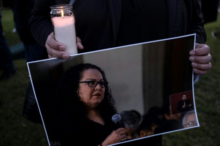 A protester holds a candle with a photo of Lourdes Maldonado, one of five journalists murdered already in 2022 in Mexico