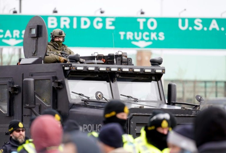Canadian police deploy on February 12, 2022, to move protesters blocking access to the Ambassador Bridge and demanding an end to government Covid-19 mandates, in Windsor, Ontario