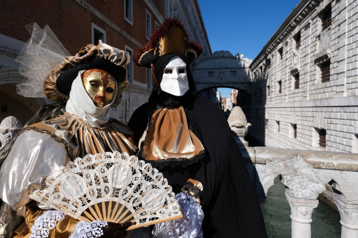 Revellers wear carnival masks and costumes to celebrate the Venice Carnival in Venice, Italy, February 12, 2022.