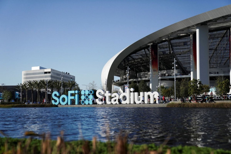 NFL fans walk past signage at SoFi Stadium, host venue for Super Bowl LVI, ahead of the NFC Championship game between the Los Angeles Rams and the San Francisco 49ers, in Inglewood, California, U.S., January 30, 2022.