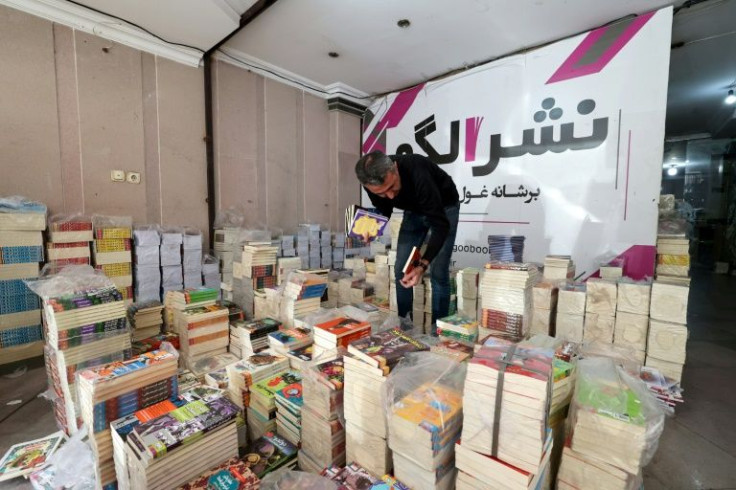 A member of staff at Iran's Houpa publishing house prepares publications for transfer to bookshops -- larger publishers have had to adapt to survive