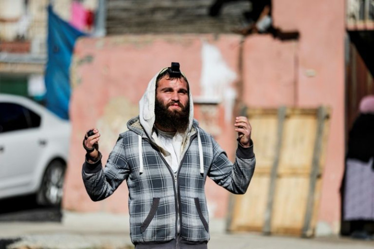An Israeli Jewish man wearing tefillin (phylactery), prays outside a Palestinian home in Sheikh Jarrah, where Itamar Ben Gvir of the far-right Religious zionism alliance opened a parliamentary office