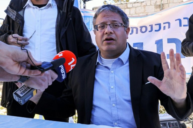 Itamar Ben Gvir speaks to reporters from a desk at his "make-shift office" in the flashpoint east Jerusalem neighbourhood of Sheikh Jarrah