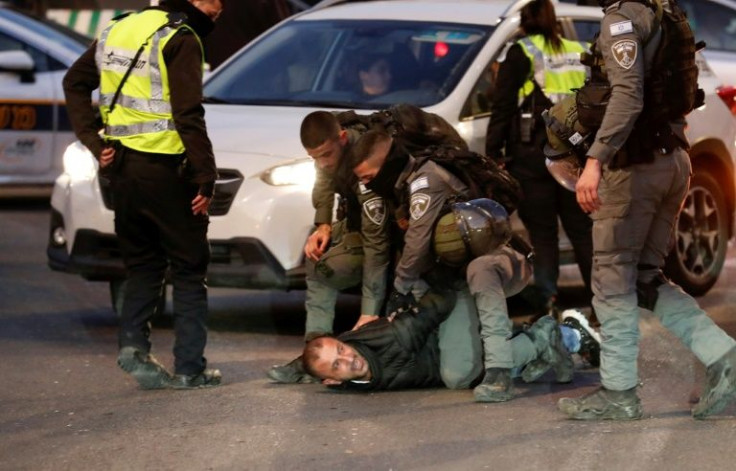 Israeli security forces detain a Palestinian man following clashes with Israeli settlers in Sheikh Jarrah