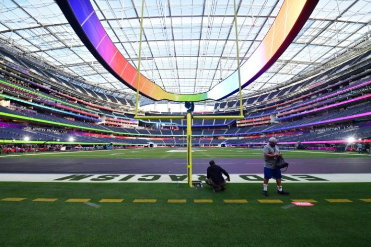 Workers put the finishing touches to the $5 billion SoFi Stadium which will host Sunday's Super Bowl between the Los Angeles Rams and Cincinnati Bengals