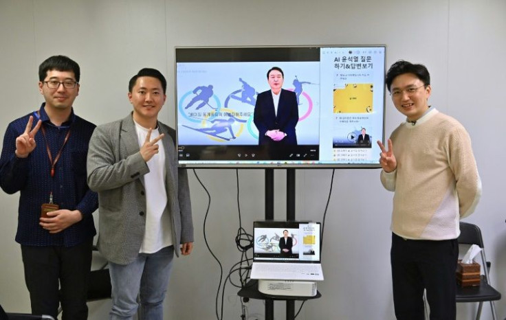 AI Yoon team director Baik Kyeong-hoon (R) and his colleagues pose with the avatar