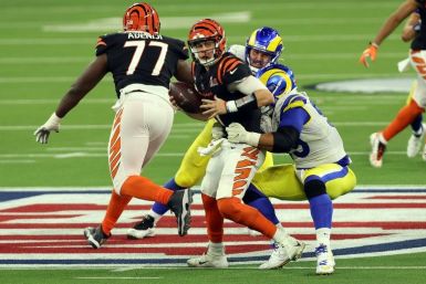 Aaron Donald of the Los Angeles Rams sacks Joe Burrow of the Cincinnati Bengals in the fourth quarter to help deliver a 23-20 Rams victory in Super Bowl 56