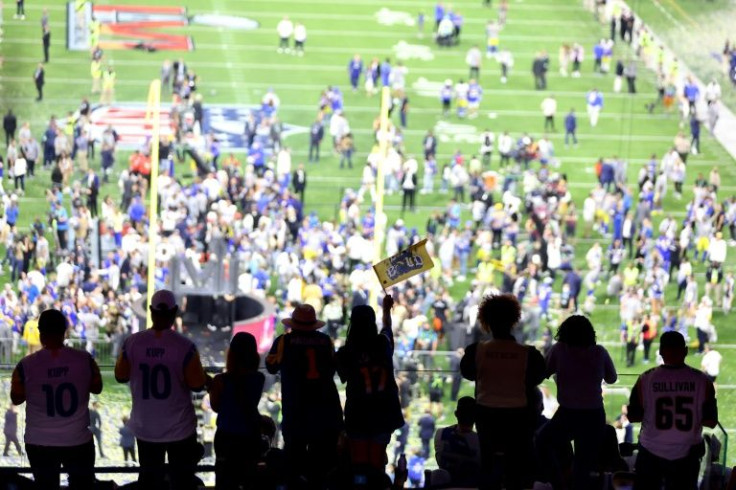 Los Angeles Rams fans cheer while watching the NFL team's players celebrate on the field after beating Cincinnati on Sunday in Super Bowl 56