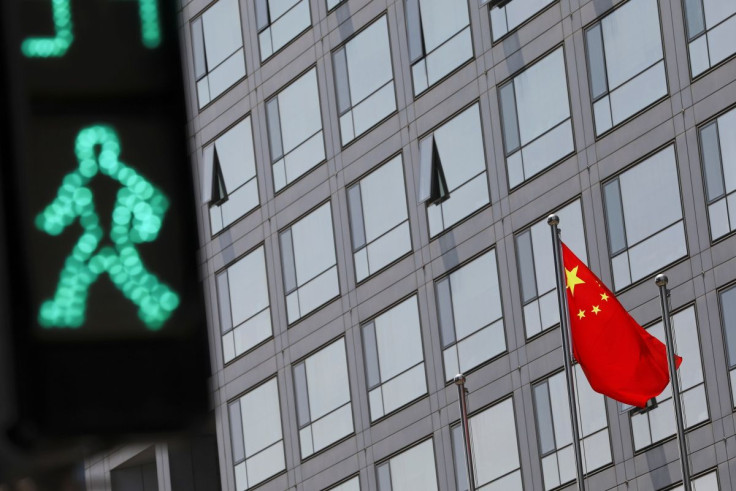 A Chinese national flag flutters outside the China Securities Regulatory Commission (CSRC) building on the Financial Street in Beijing, China July 9, 2021. 