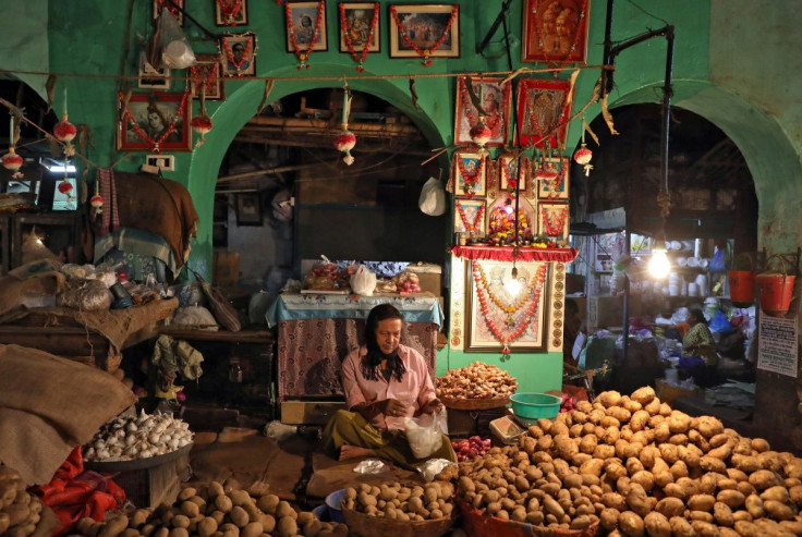 A vendor waits for customers at his shop inside a vegetable market in Kolkata, India, February 12, 2020. 