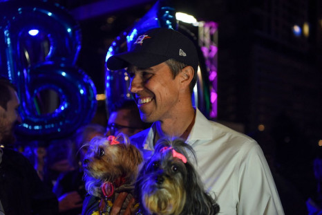 Texas Democratic gubernatorial candidate Beto O'Rourke holds two dogs as he poses for a photograph following a campaign event in Houston, Texas, U.S., November 19, 2021.  