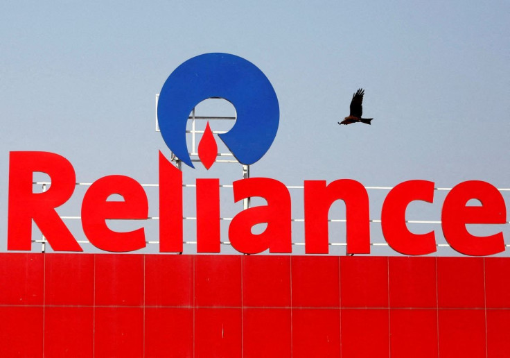 A bird flies past a Reliance Industries logo installed on its mart in Ahmedabad, India January 16, 2017.